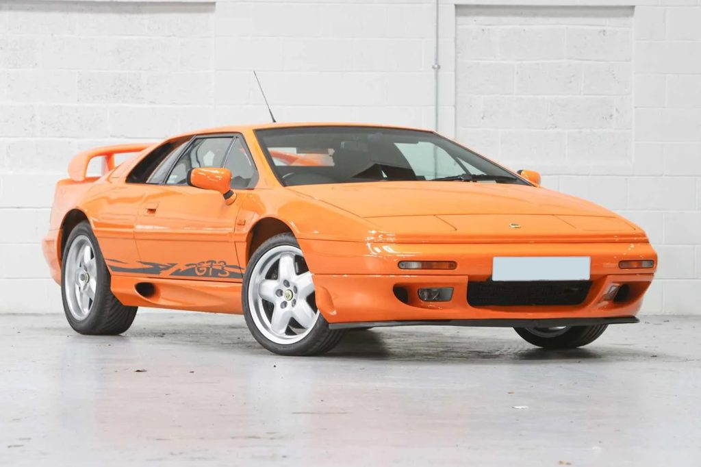 Orange 1999 Lotus Esprit GT3 front three-quarter view in a white studio
