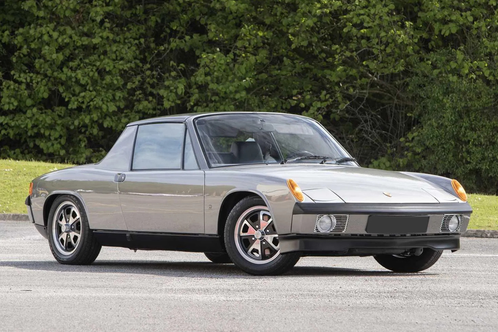 Silver 1970 Porsche 914 targa, front three-quarter view on a tree-lined road