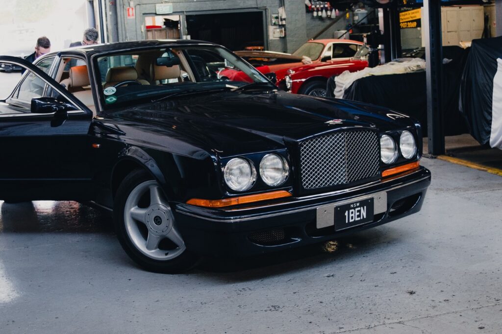 Black 1996 Bentley Continental R Jack Barclay Edition coupe inside a workshop among other classic cars